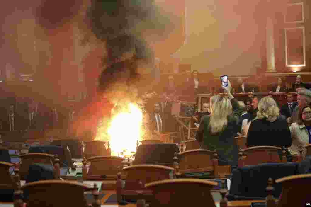 Democratic lawmakers throw a flare during a parliament session in Tirana, Albania.&nbsp; Opposition lawmakers disrupted the Parliament&#39;s session again to protest against what they say, is increasingly authoritarian rule by the governing Socialists.&nbsp;
