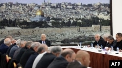 This handout picture provided by the Palestinian Authority's press office (PPO) shows President Mahmud Abbas, center, chairing a meeting for the Palestinian leadership in Ramallah city in the Israel-occupied West Bank, Feb. 18, 2024. 
