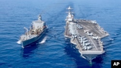 FILE - USS Gerald R. Ford aircraft carrier refuels from the underway replenishment oiler USNS Laramie in the eastern Mediterranean Sea, Oct. 11, 2023. (U.S. Navy photo via AP)