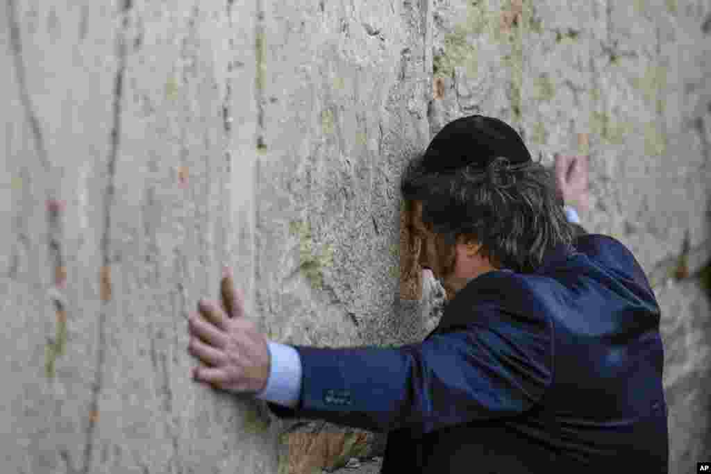 Argentine President Javier Milei touches the Western Wall, the holiest site where Jews can pray, in Jerusalem&#39;s Old City.