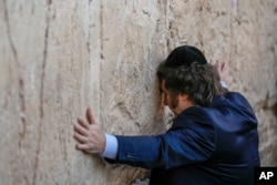 Argentine President Javier Milei touches the Western Wall, the holiest site where Jews can pray, in Jerusalem's Old City, Feb. 6, 2024.
