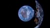 资料照片：直觉机器公司发射的“奥德修斯”号登月器和远处的地球。(2023年2月16日）