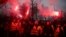 Demonstrators hold flares as Polish farmers protest over price pressures, taxes and green regulation, grievances shared by farmers across Europe, in Poznan, Poland, Feb. 9, 2024.