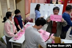 FILE - Polling officers count votes in New Taipei City, Taiwan, Jan. 13, 2024. (AP Photo/Ng Han Guan)