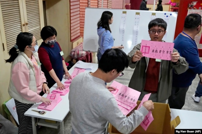 FILE - Polling officers count votes in New Taipei City, Taiwan, Jan. 13, 2024. (AP Photo/Ng Han Guan)