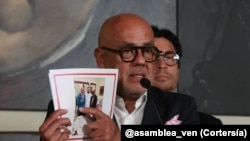 Jorge Rodríguez, presidente del Parlamento de mayoría oficialista de Venezuela muestra una fotografía en la que se le ve junto a Brian Nichols durante un proceso directo de negociaciones. 