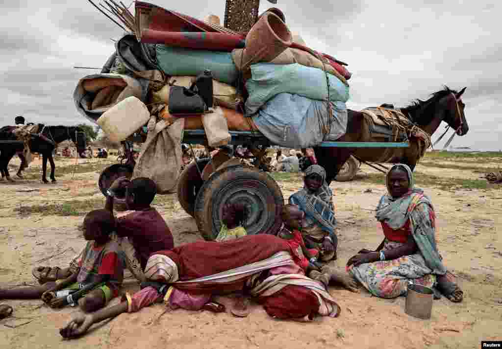 Sudanese family who fled the conflict in Murnei in Sudan&#39;s Darfur region, rest next to their belongings while waiting to be registered by UNHCR upon crossing the border between Sudan and Chad in Adre, Chad, July 26, 2023.