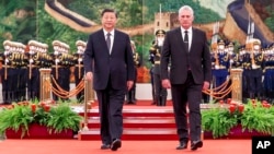 FILE - Chinese President Xi Jinping and Cuba's President Miguel Diaz-Canel Bermudez walk during a welcome ceremony in Beijing, Nov. 25, 2022. They pledged mutual support over their fellow communist states' "core interests."