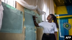 A Rwanda National Electoral Commission official marks votes on a tally sheet after polls closed in the general election, at a polling station in Kigali, July 15, 2024. Incumbent President Paul Kagame won an overwhelming victory, results showed.