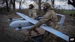 FILE - Ukrainian soldiers prepare to launch a Poseidon H10 middle-range drone near the city of Bakhmut, in Ukraine’s Donetsk region, March 26, 2024.