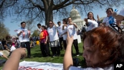 FILE - Immigrants from Nepal dance during a "Rally for Citizenship" on Capitol Hill in Washington, April 10, 2013. Granted special protections under President Barack Obama, they have been ordered by the administration of President Donald Trump to leave the U.S. by June 24, 2019.