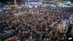 In this photo released by Xinhua News Agency, travelers prepare to catch their trains at the crowded Hankou Railway Station in Wuhan, central China's Hubei Province, on Sept. 28, 2023.
