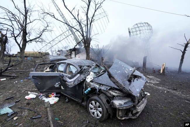 FILE - Damaged radar, a vehicle and equipment are seen at a Ukrainian military facility outside Mariupol, Ukraine on Feb. 24, 2022. (AP Photo/Sergei Grits, File)