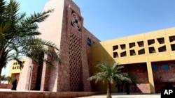 FILE - A Qatari student walks to a building in the Texas A&M University campus at Education City, on Oct. 18, 2011, in Doha, Qatar.