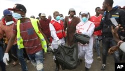Rescuers carry sacks with human remains after being removed from a quarry in Mukuru Kwa Njenga area in Nairobi, Kenya, July 13, 2024. 