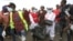 Rescuers carry sacks with human remains after being removed from a quarry in Mukuru Kwa Njenga area in Nairobi, Kenya, July 13, 2024. 
