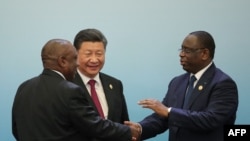 FILE - Chinese President Xi Jinping (C) with South African President Cyril Ramaphosa (L) and Senegalese President Macky Sall (R) attend a joint press conference during the Forum On China-Africa Cooperation at the Great Hall of the People in Beijing on Sept. 4, 2018. 