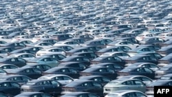 FILE - This aerial photo taken Oct. 15, 2023 shows newly-produced new energy electric vehicles parked at a distribution center of Changan Automobile in China's southwestern Chongqing.