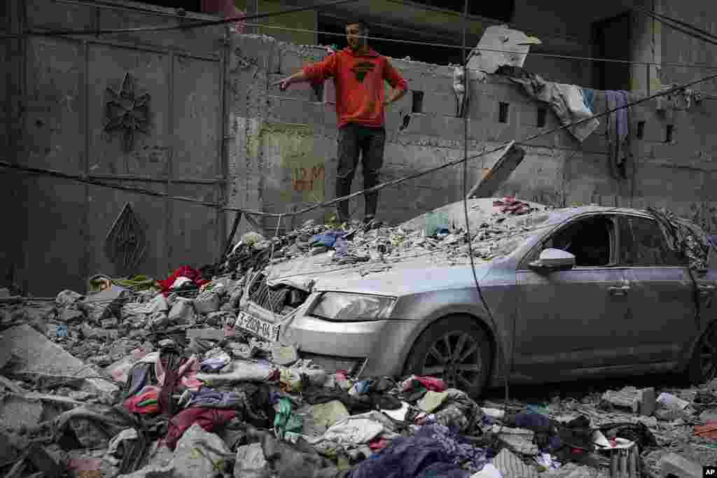 Palestinians look at the destruction after an Israeli airstrike in Rafah, Gaza Strip. (AP Photo/Fatima Shbair)