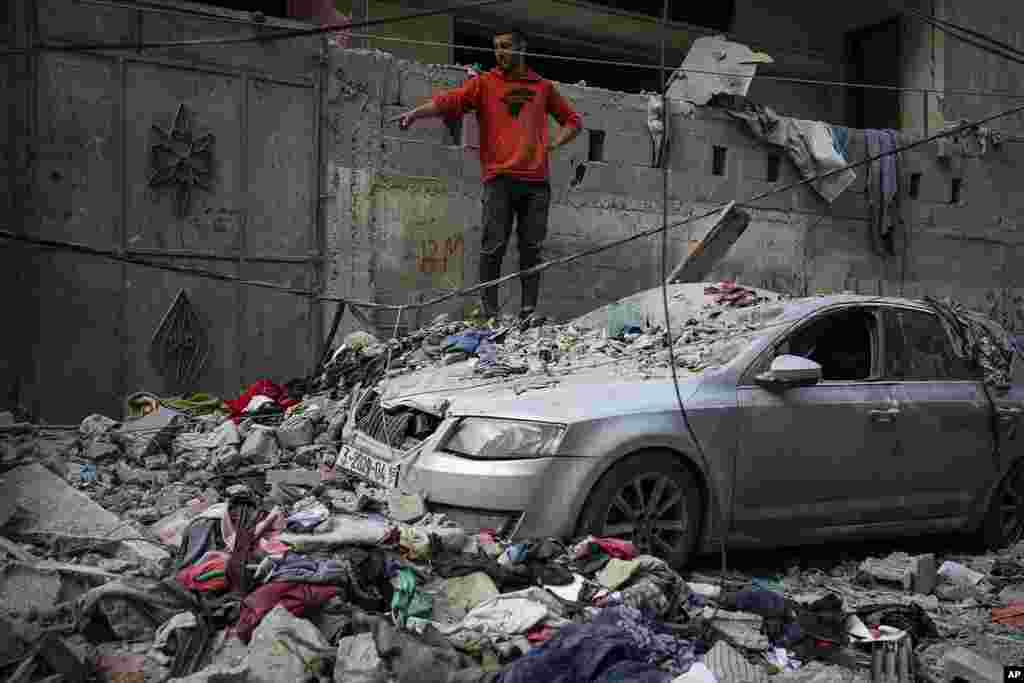 Palestinians look at the destruction after an Israeli airstrike in Rafah, Gaza Strip.