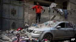 Palestinians look at the destruction after an Israeli airstrike in Rafah, Gaza Strip. (AP Photo/Fatima Shbair)
