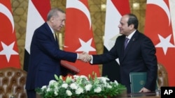 Turkey's President Recep Tayyip Erdogan, left, and Egyptian President Abdel Fattah el-Sissi shake hands during their meeting at Ittihadiya palace in Cairo, Egypt, Feb. 14, 2024. (Turkish Presidency handout via AP)