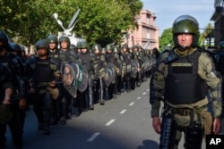 Security forces deploy during a march to protest against the Milei government's new shock economic measures, in downtown Buenos Aires, Argentina, Dec. 20, 2023.