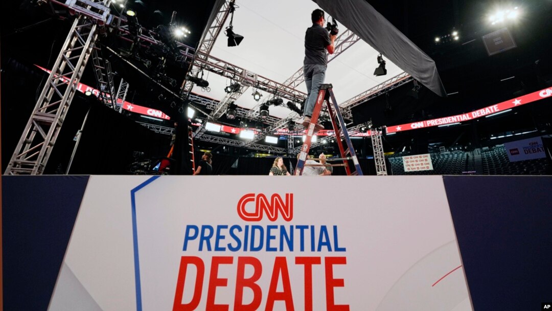 Ben Starett, lighting programmer for CNN, sets up lights in the spin room for the presidential debate between President Joe Biden and former President Donald Trump in Atlanta, June 26, 2024.