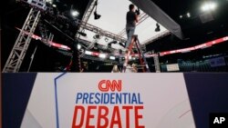 Ben Starett, lighting programmer for CNN, sets up lights in the spin room for the presidential debate between President Joe Biden and former President Donald Trump in Atlanta, June 26, 2024.