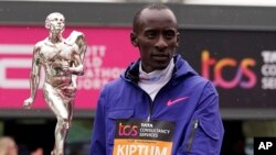 FILE - Men's race winner Kelvin Kiptum of Kenya holds a trophy after the London Marathon in London, Britain, April 23, 2023. Kiptum died in a car crash in Kenya Feb. 11, 2024, at age 24.