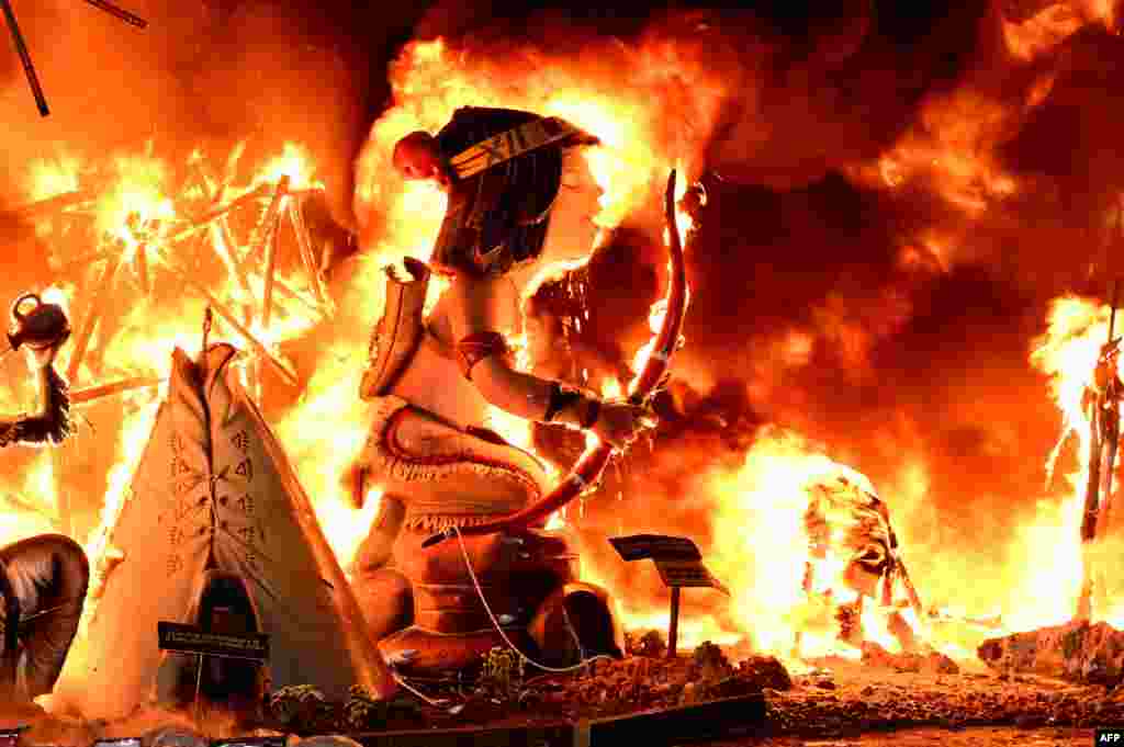 Ninots (cardboard figurines) in a &#39;falla&#39; (a huge ornate cardboard sculpture made to eventually be burnt) are seen burning on the night of the Fallas Festival in Valencia, Spain, March 19, 2023.
