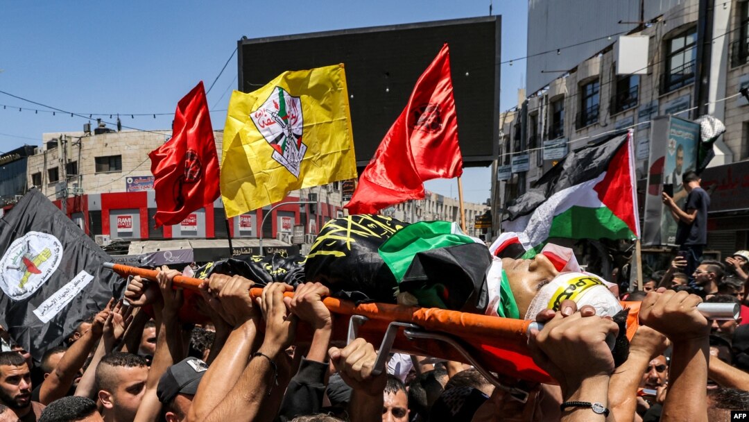 FILE - Mourners carry the body of a Palestinian killed in clashes in the occupied West Bank, July 5, 2023. Israeli forces killed a Palestinian on Thursday in the occupied West Bank city of Nablus, the Palestinian health ministry said. 