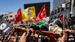 FILE - Mourners carry the body of a Palestinian killed in clashes in the occupied West Bank, July 5, 2023. Israeli forces killed a Palestinian on Thursday in the occupied West Bank city of Nablus, the Palestinian health ministry said. 