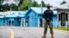 FILE - South Korean soldier, right, and United Nations Command soldier (background, in green) stand guard near the military demarcation line separating North and South, at the Joint Security Area of DMZ in the truce village of Panmunjom, Oct. 4, 2022.