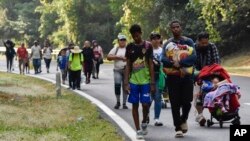 ARCHIVO — Migrantes caminan por Villa Comaltitlán, estado de Chiapas, sur de México, el 27 de diciembre de 2023, rumbo a la frontera con Estados Unidos. Algunos líderes estatales dicen que no pueden hacer frente al volumen de inmigrantes.