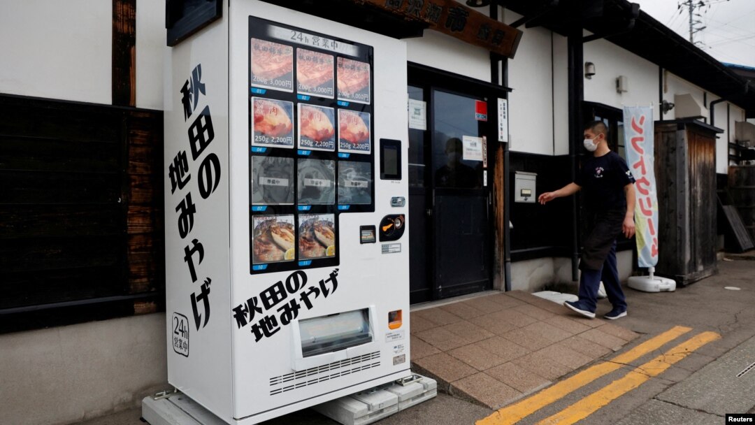 Menu mesin penjual otomatis menawarkan daging Beruang Hitam Asia, Daging Sapi Akita, dan ikan sungai kering di depan restoran Mie Soba di Semboku, prefektur Akita, Jepang, 6 April 2023. (REUTERS/Irene Wang)