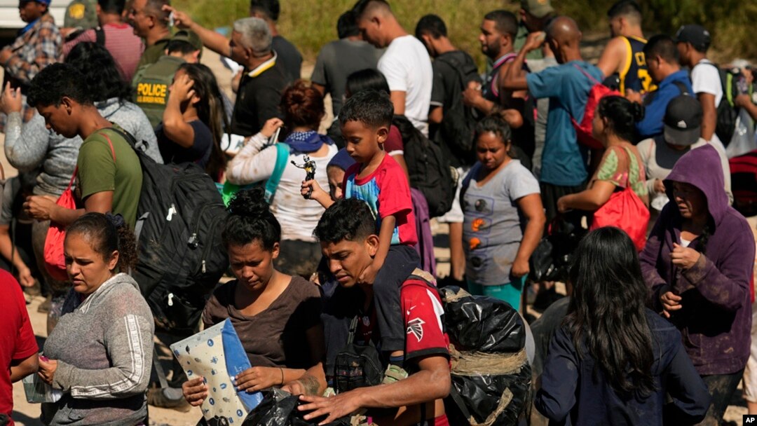 FILE - Migrants wait to be processed by U.S. Customs and Border Protection after they crossed the Rio Grande and entered the U.S. from Mexico, Oct. 19, 2023, in Eagle Pass, Texas.