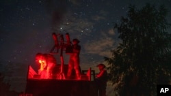 A volunteer for an air-defense unit prepares a machine gun near Bucha, Kyiv region, Ukraine, Aug. 9, 2024.