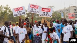 Supporter of the Alliance Of Sahel States hold placards reading 'No to ECOWAS' during a rally to celebrate Mali, Burkina Faso and Niger leaving the Economic Community of West African States in Bamako, Mali, on Feb. 1, 2024. 