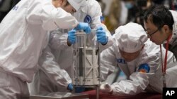 FILE - In this Thursday, Dec. 17, 2020 photo provided by China's Xinhua News Agency, technicians prepare to weigh a container carrying moon samples retrieved by China's Chang'e 5 lunar lander in Beijing. (Jin Liwang/Xinhua via AP, File)