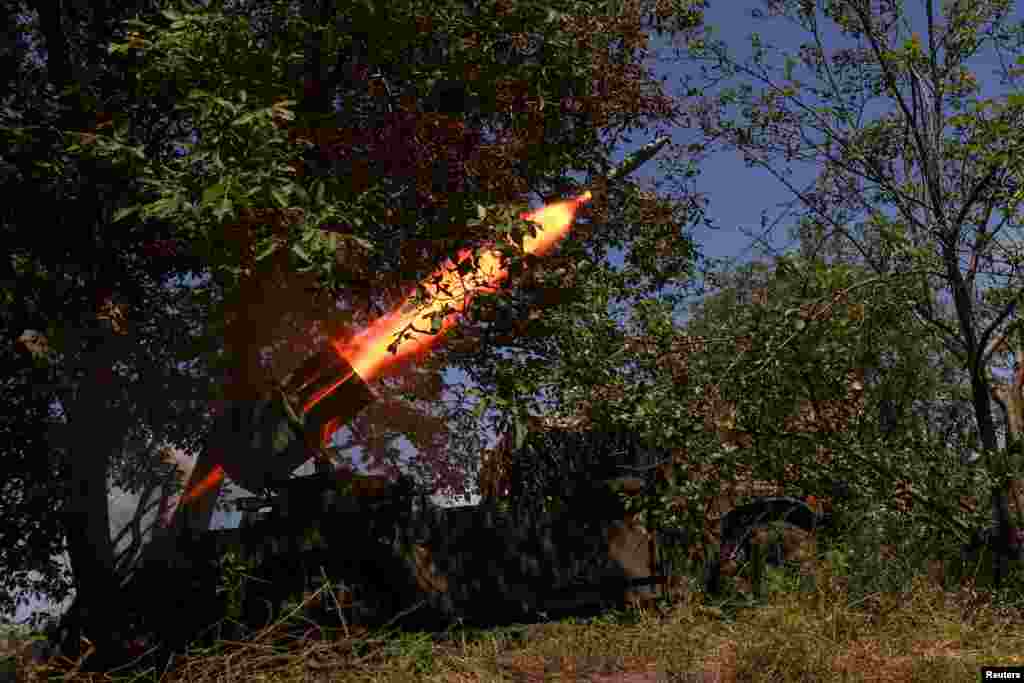 Ukrainian servicemen fire an RAK-SA-12 small multiple launch rocket system toward Russian troops near the front line town of Bakhmut in the Donetsk region, July 10, 2023.