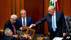Lebanese Parliament Speaker Nabih Berri, right, casts his vote as parliament gathers to elect a president at the parliament building in downtown Beirut, Lebanon, June 14, 2023. 