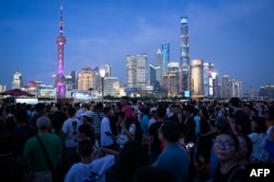 Tourists visit the Bund waterfront area in Shanghai, China, July 5, 2023.