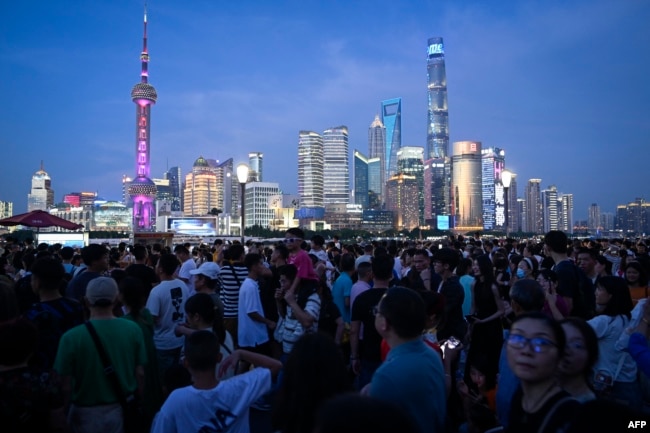 Tourists visit the Bund waterfront area in Shanghai, China, July 5, 2023.