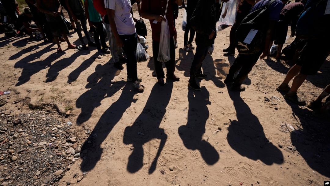FILE - Migrants wait to be processed by U.S. Customs and Border Protection after they crossed the Rio Grande and entered the U.S. from Mexico, in Eagle Pass, Texas, Oct. 19, 2023. 