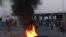 FILE: Tunisian youths set tires afire as tensions rose in Sfax after the burial of a young Tunisian stabbed to death during a scuffle between residents and migrants from sub-Saharan Africa, on July 4, 2023. Three African migrants were arrested as suspects in the killing.