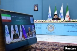 Iranian President Ebrahim Raisi attends the 23rd Shanghai Cooperation Organization Council of Heads of State Summit via video link, at the Office of the President of Iran, in Tehran, Iran, July 4, 2023. (Iran's Presidency/WANA/Handout via Reuters)