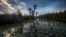 FILE - The sun sets over water lilies and cypress trees along the remote Red Trail wilderness water trail of Okefenokee National Wildlife Refuge, April 6, 2022, in Fargo, Ga. 