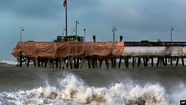 FILE - Large waves crash along the Southern California coast near the Ventura Pier in Ventura, Calif. on Dec. 30, 2023.