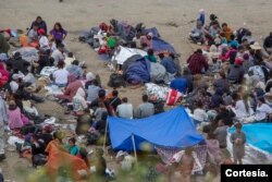 Migrantes de diferentes nacionalidades esperan en un campamento improvisado en la ciudad de Tijuana, México. Foto: Aimee Melo